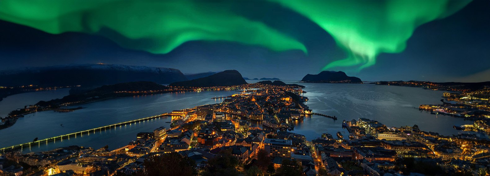 Image of the Northern Lights over a snowy fjord